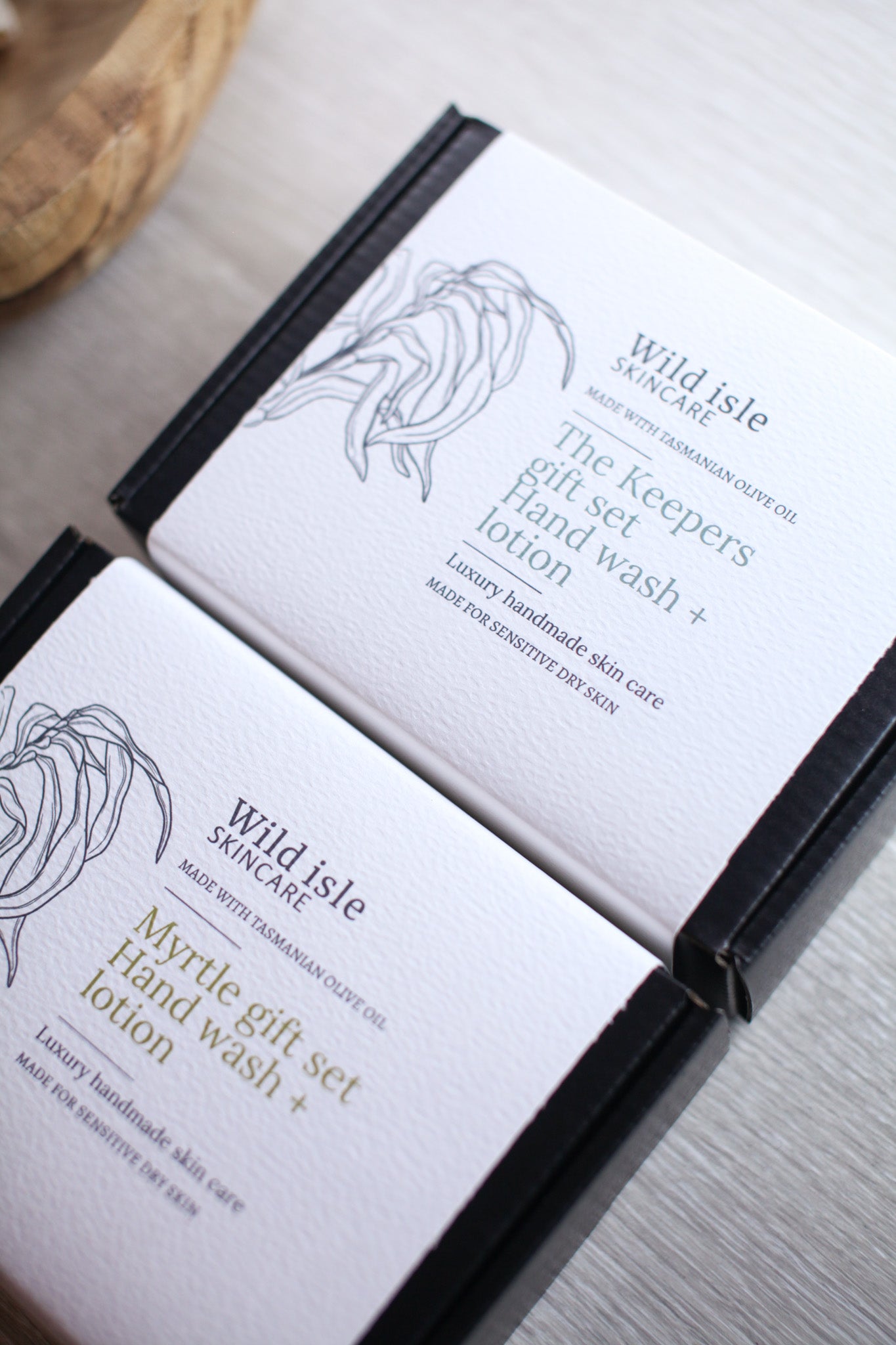 Two Wild Isle Skincare product boxes on a light surface