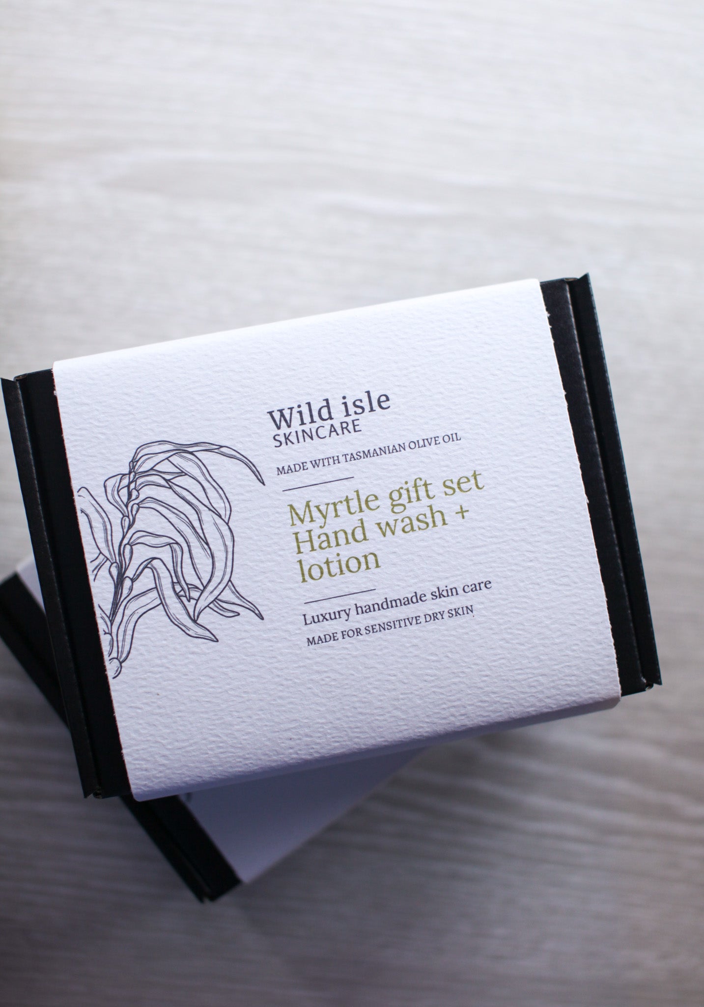 Wild Isle Skincare myrtle gift set packaging on a gray background